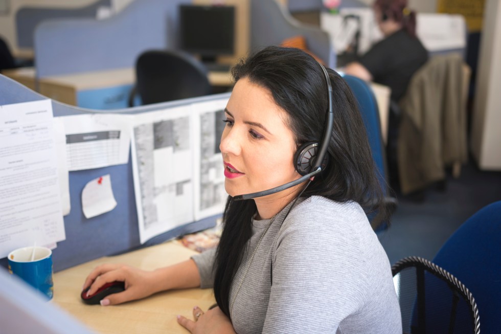 Operator woman talking on headset at work