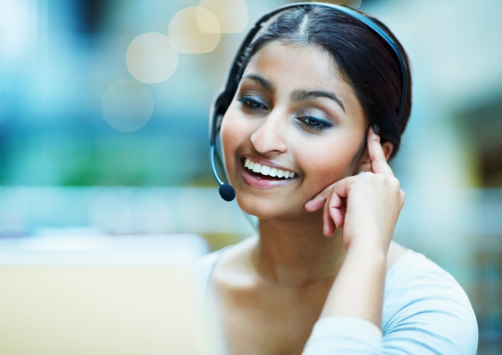 Female customer service representative using headset and laughing