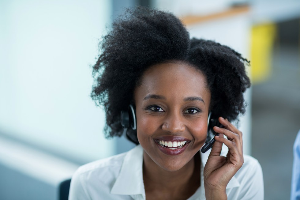 Portrait of business executives talking on headset in office