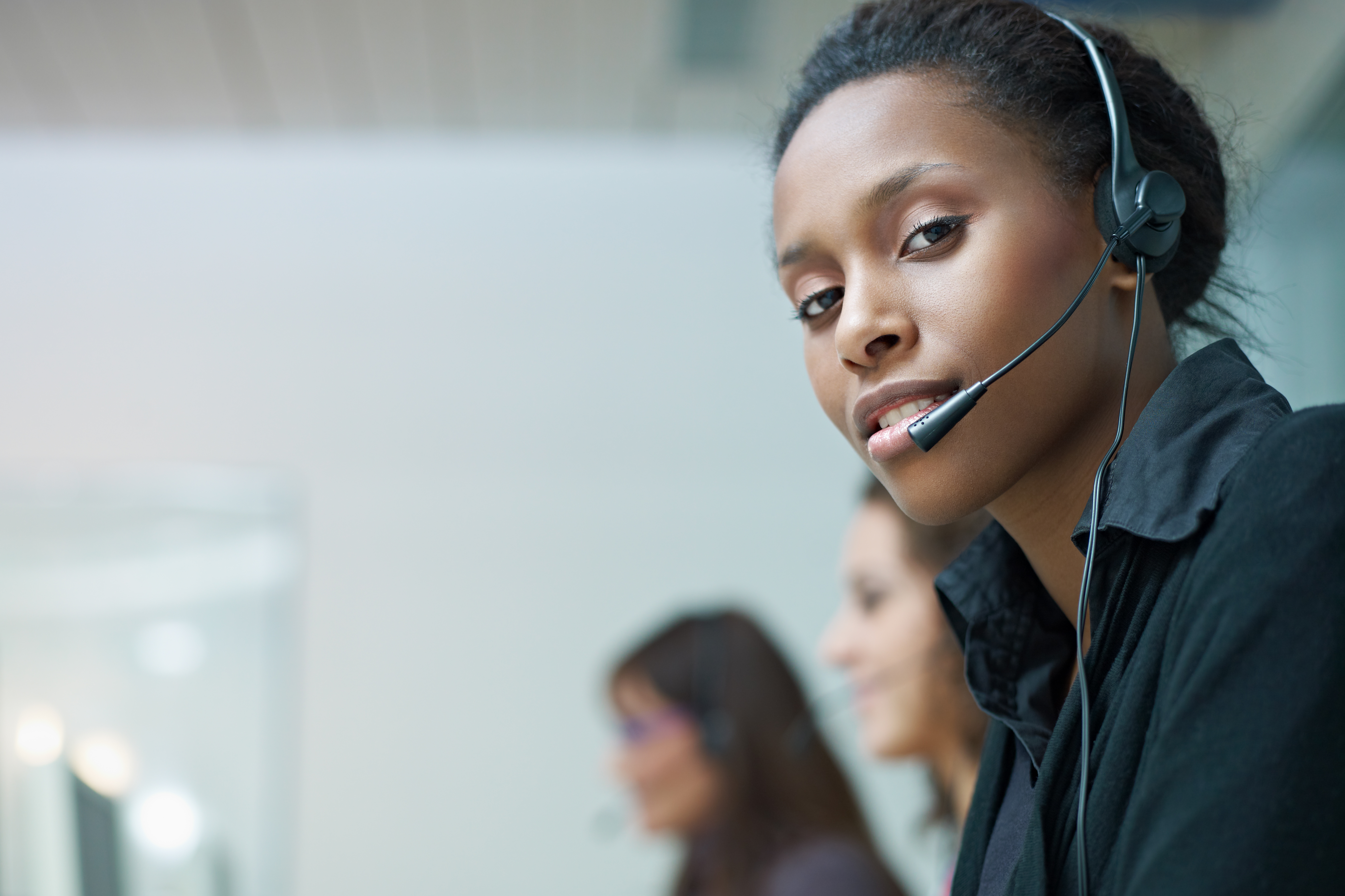 Women with headsets working at a call center